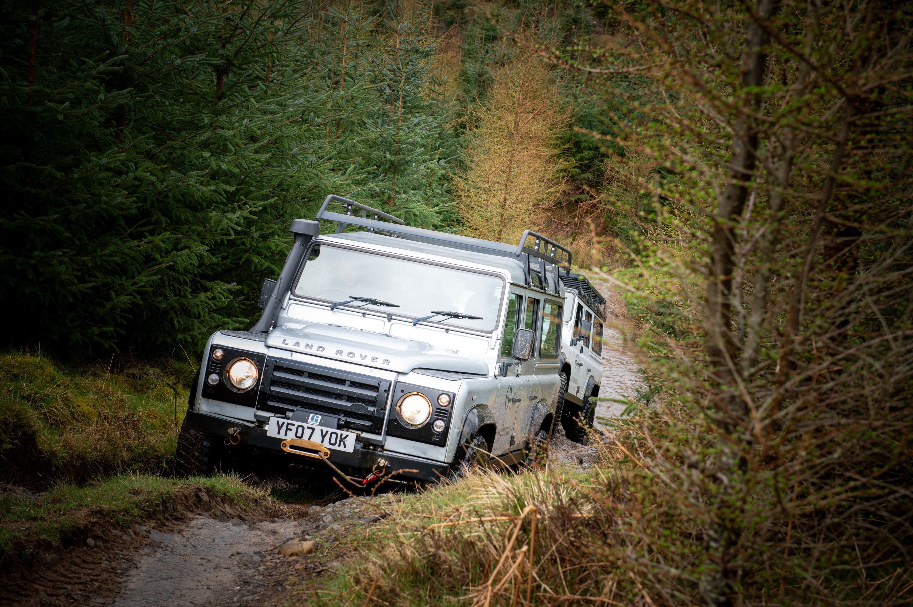 Land Rover's driving through the countryside