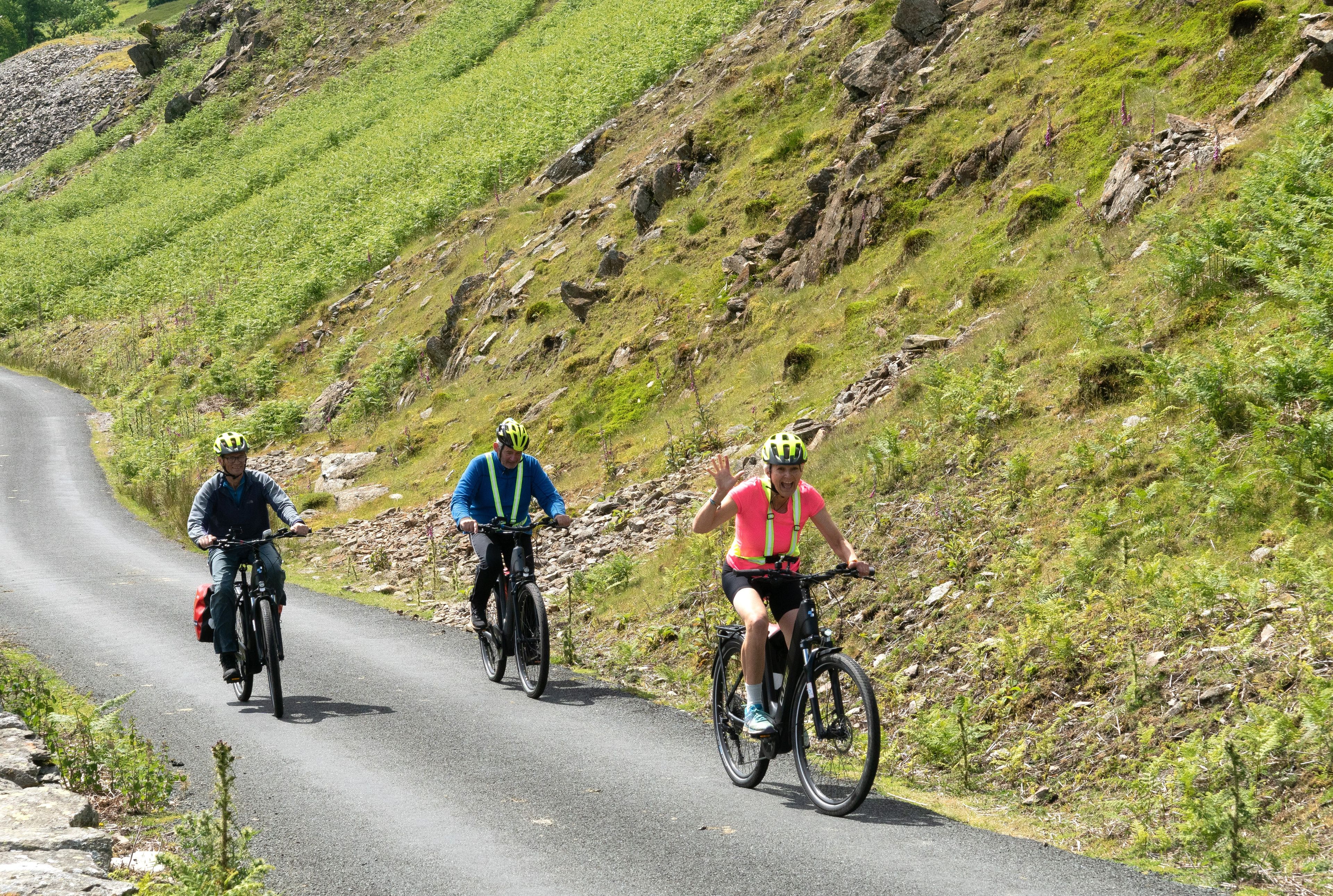 A trio riding bikes by the hills