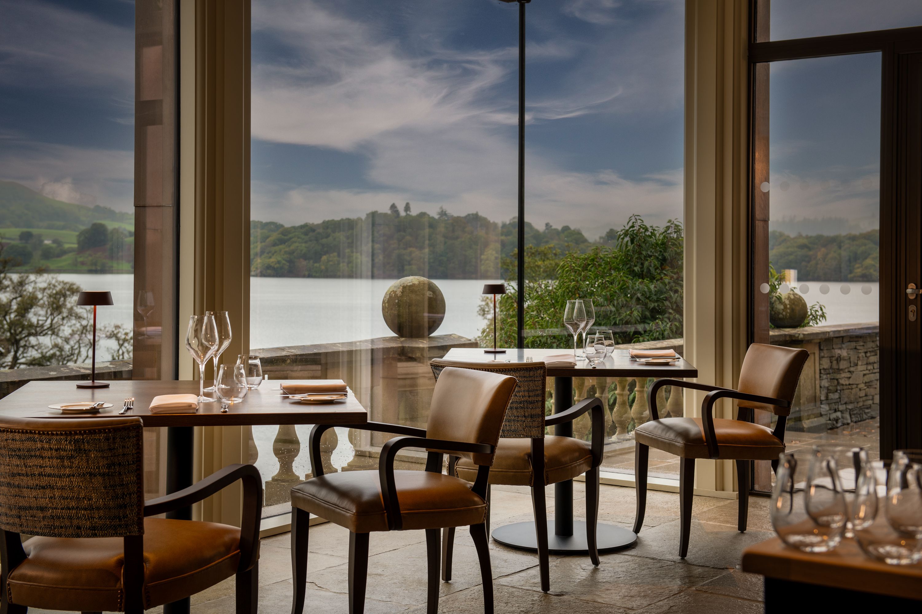 Dining room with large windows and a lake view.