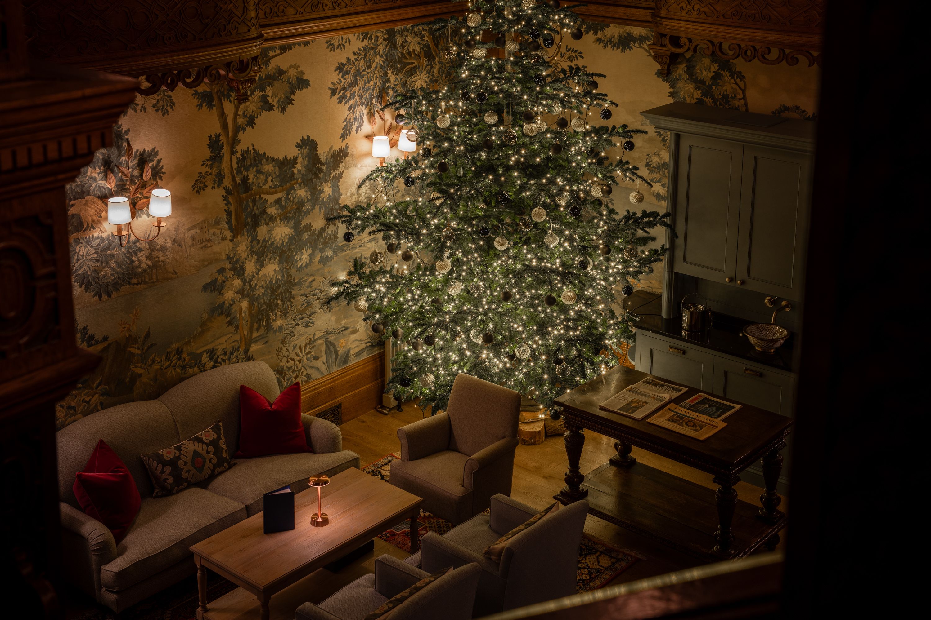 Birds eye view of a large, well-lit Christmas tree in the lounge area