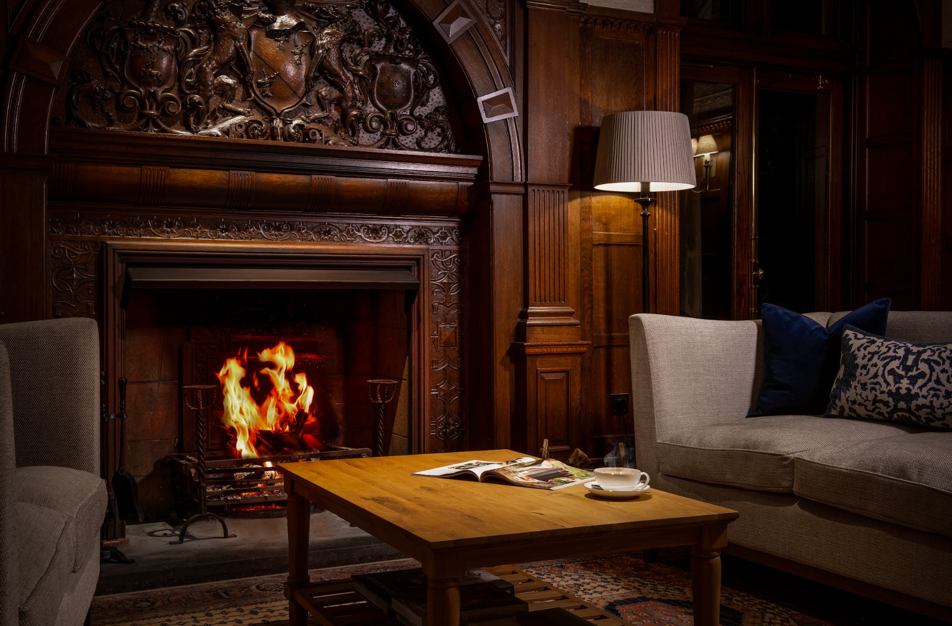 A burning fireplace in the lounge area