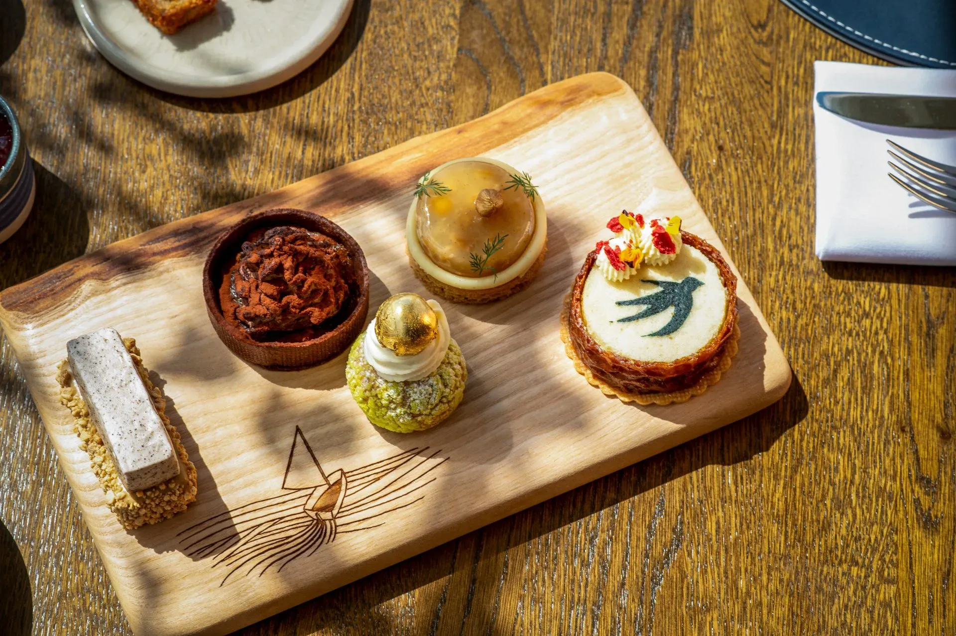 afternoon tea with pastries on a wooden board