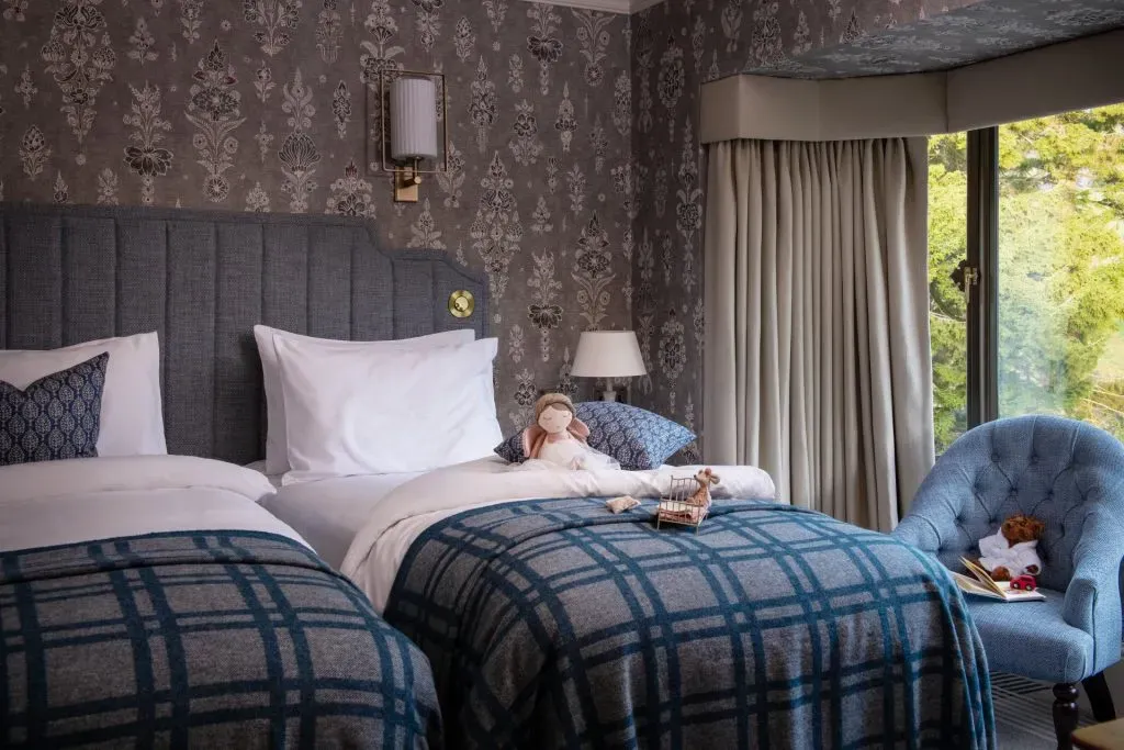 twin beds in a hotel room with toys