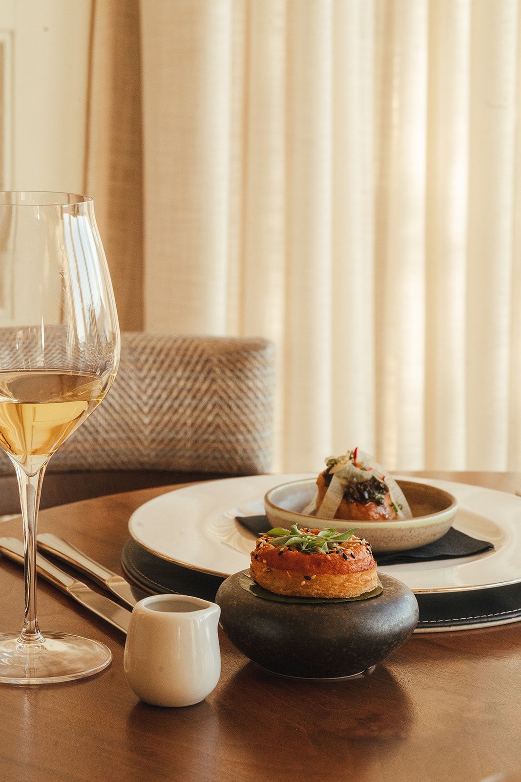 Pastry dish and a glass of white wine